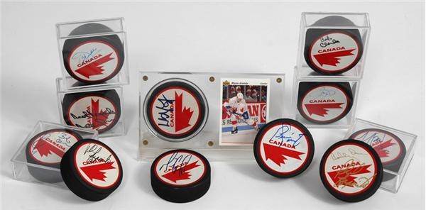 - Stanley Cup Centennial Signed Book and 33 Signed Canada Cup Pucks