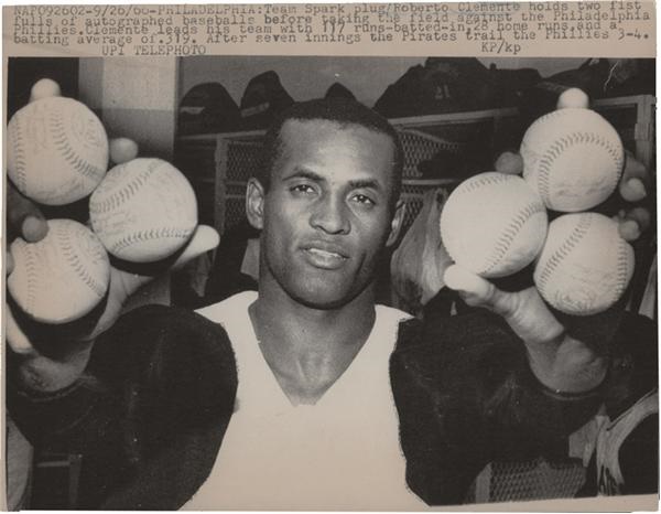- Roberto Clemente Holds Team Signed Baseballs Photo (1966)