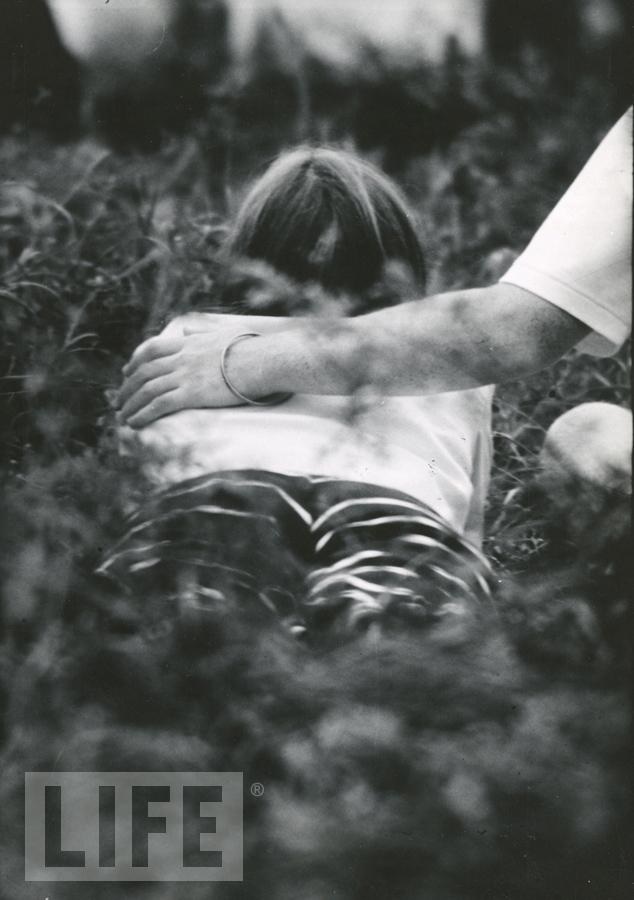 - Woman Lying in the Grass at Woodstock by Bill Eppridge (1938- )